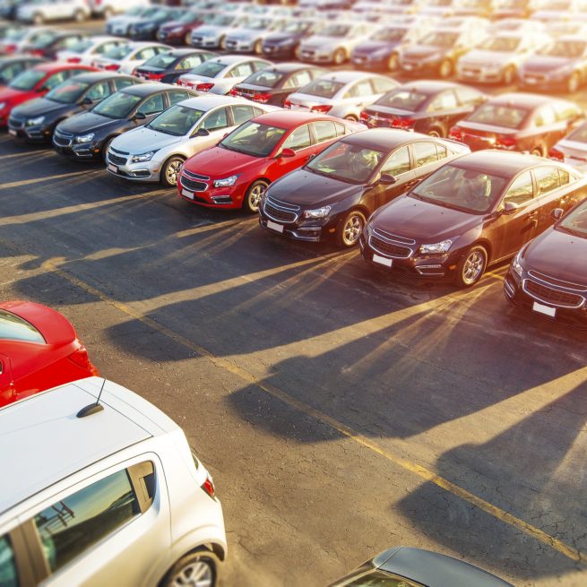 Dealer New Cars Stock. Colorful Brand New Compact Vehicles For Sale Awaiting on the Dealer Parking Lot. Car Market Business Concept.